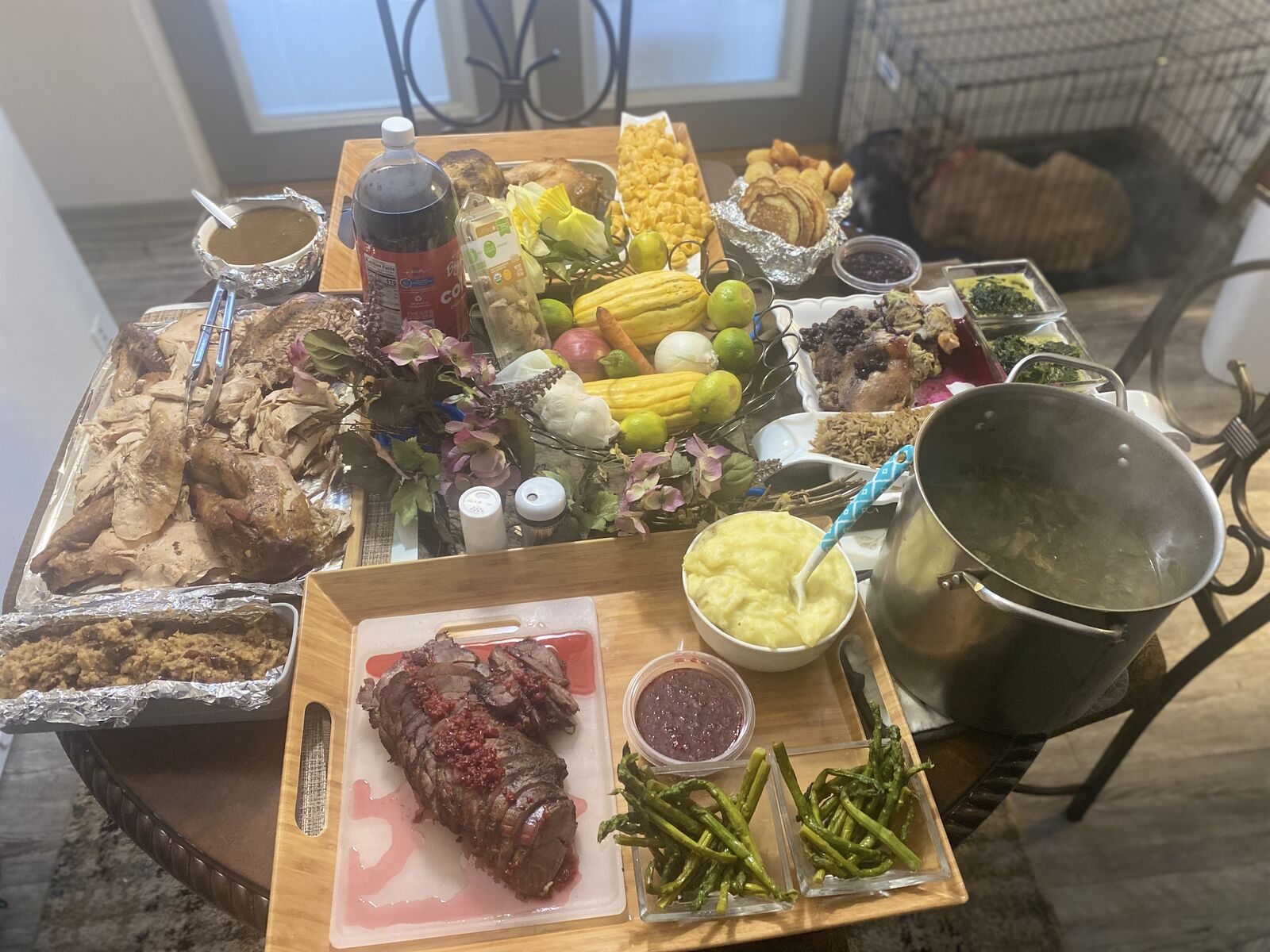 Spread of roasted meats, sides and desserts laid out for a catered gathering