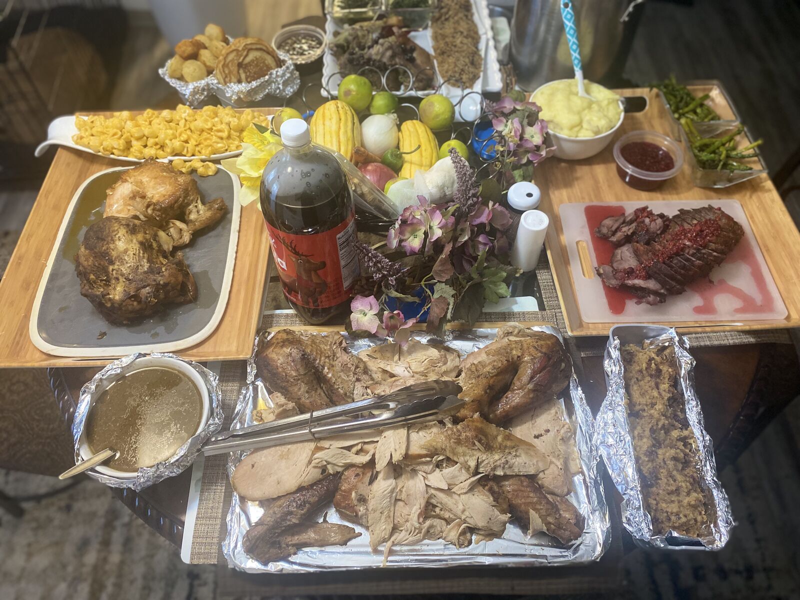 Holiday table with turkey, mac and cheese, steak and sides