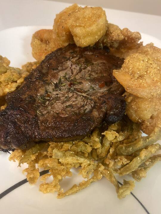 Seared ribeye with crispy shrimp and fried onions