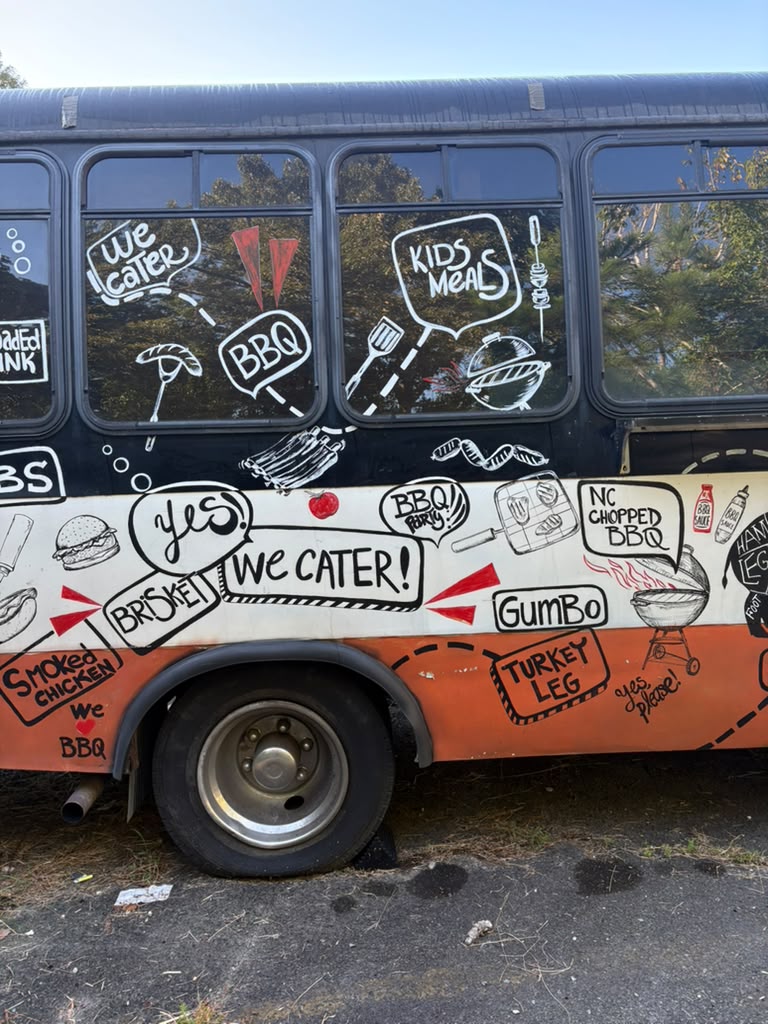 Catering truck with hand-drawn barbecue artwork and We Cater lettering